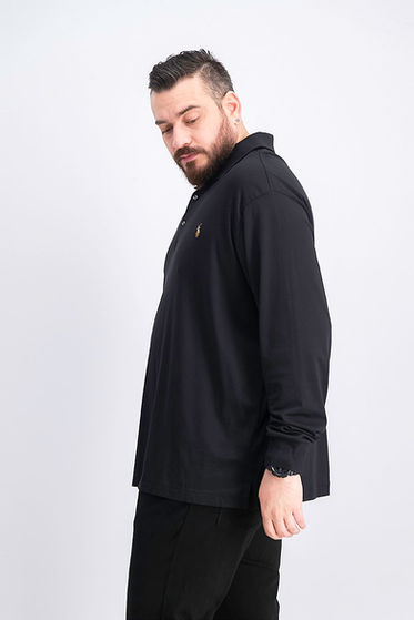 Hadi wearing all black, looking down