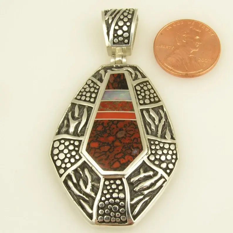 Dinosaur bone pendant with opal and coral accents in sterling silver.