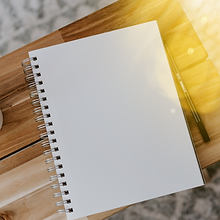 Blank notebook and pen on a wooden bench