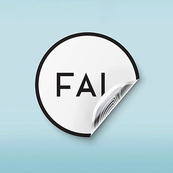 A round sticker with the text “FAI” partially peeled on a light blue background, suggesting a minimalist style and simplicity.