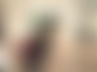 People view colorful artwork in an art museum. Some sit on benches using mobile phones. Neutral walls and large windows complement the setting. The Fine Art Ledger. Technology. The Met Museum. New York. Art