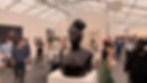 Zanele Muholi, Southern Guild Gallery Frieze Art Fair Los Angeles 2026. Art exhibit with a large black bust in the foreground. People browse artwork on white walls. Signs read "A12" and "Southern Guild."