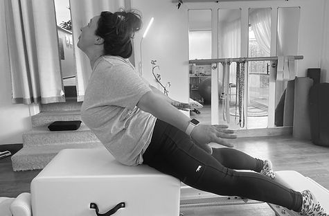 Client on reformer in back extension