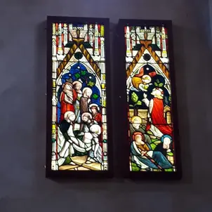 Two stained glass installations illuminated from behind showing biblical scenes