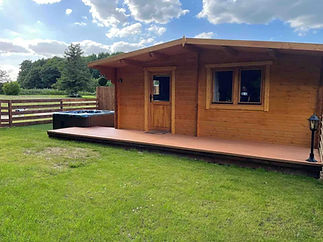 Owl Lodge log cabin on a bright day