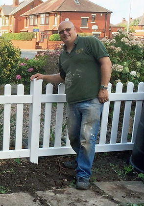 Business owner Neil Vacciano poses with a newly installed fence