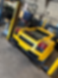 Yellow sports car in garage ready for repair work