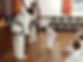 Young student and instructor bowing to each other