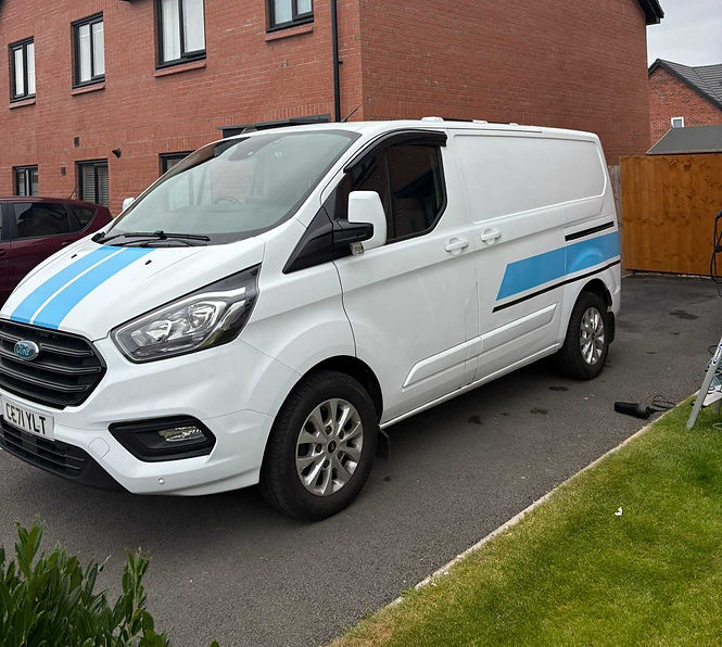 White van parked outside building