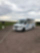 Mini bus waiting outside a grassy area after drop-off