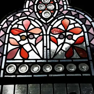 Stained glass with geometric design in Gothic-style frame
