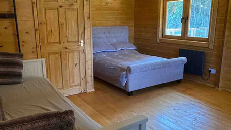 Cozy interior of Owl Lodge showing sofa beds