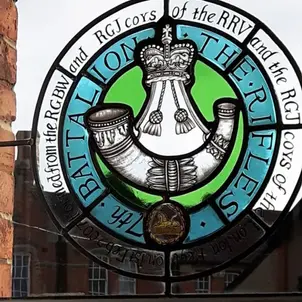 Round stained glass installation showing Battalion of the Rifles emblem