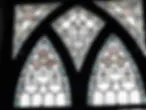 Stained glass with geometric design in Gothic-style frame