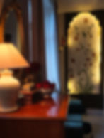 South Asian interior design with arched wall art and lamp