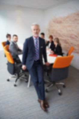 white man walking away from team.jpg
