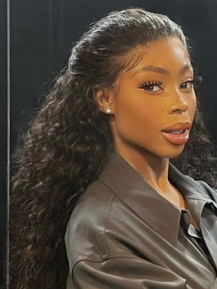 Wunmi Bello in a deep wave curly wig styled as an up down do