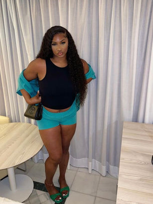 Brown skinned girl in a side part water wave wig