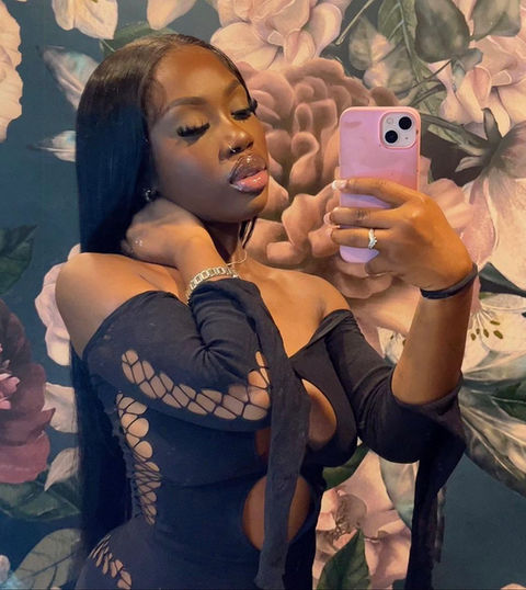 Dark skinned girl with a buss down jet black middle part look