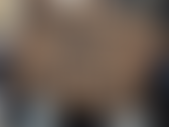 A person standing on a city street holding a large cardboard sign that reads “QUALITY AND TRUST MATTERS” in bold black letters, with other pedestrians and tall buildings blurred in the background.