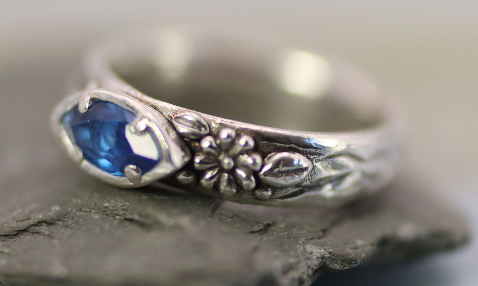 Close-up view of a handcrafted silver pendant inspired by nature