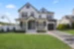 Front exterior of a newly built single-family home featuring modern architectural details, landscape