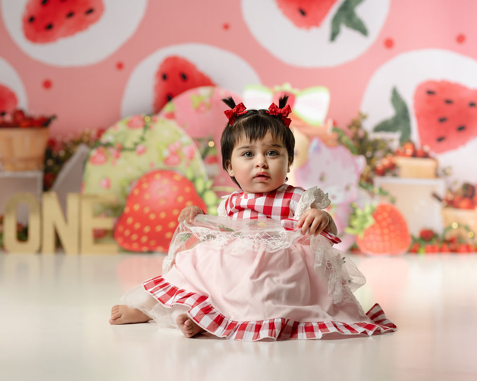 Cake smash photogrpahy session near verrado arizona featuring strawberries and a little girl in a checkered dress photographed by TAQ PHOTOGRAPHY in Buckeye Arizona