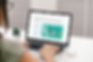 digital-mockup-featuring-a-woman-using-a-macbook-at-an-office-m21892-r-el2.png