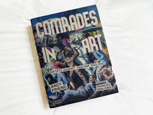 Book cover on a white background featuring dynamic figures and bold colors. Text: "Comrades in Art," "Artists Against Fascism 1933-1943," "Andy Friend," and "Frances Spalding."