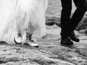 a photo of peoples feet as they walk in wedding attire.