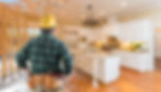 Contractor Standing In Front Custom Kitchen Construction Framing Gradating Into Finished B