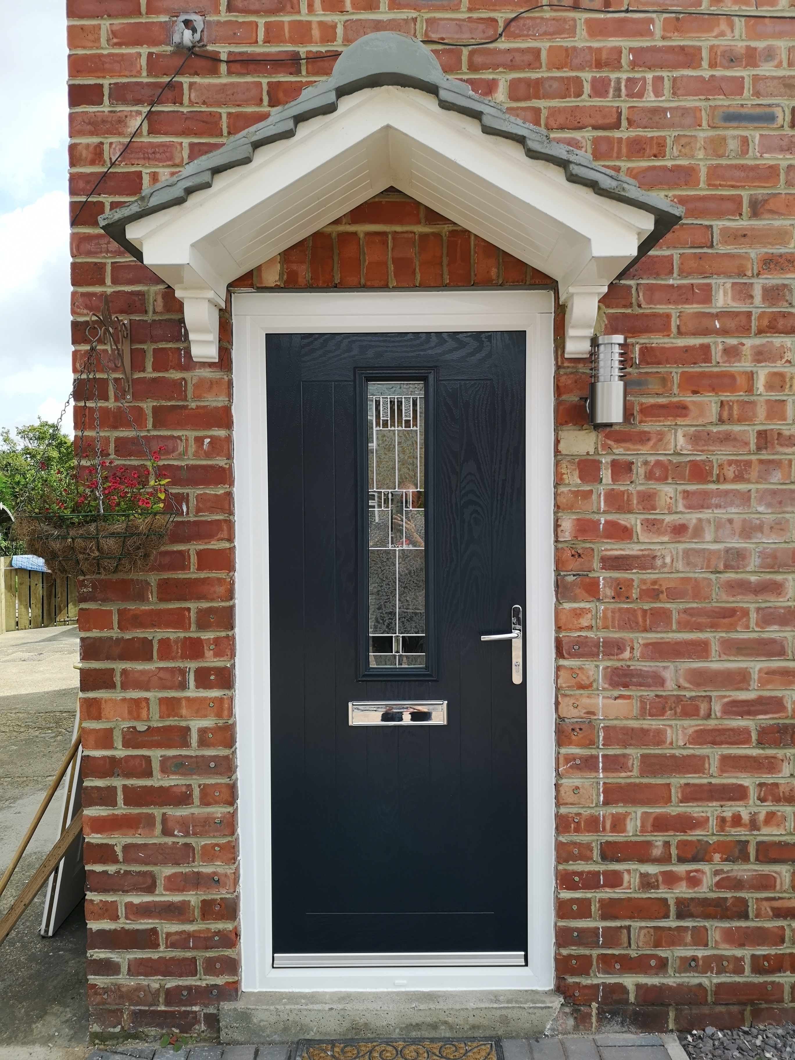 Farmhouse style Composite Door with Zinc Prairie glass.