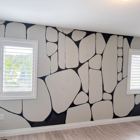Modern black and cream mural featuring simple abstract forms and a clean, sophisticated minimalist design.