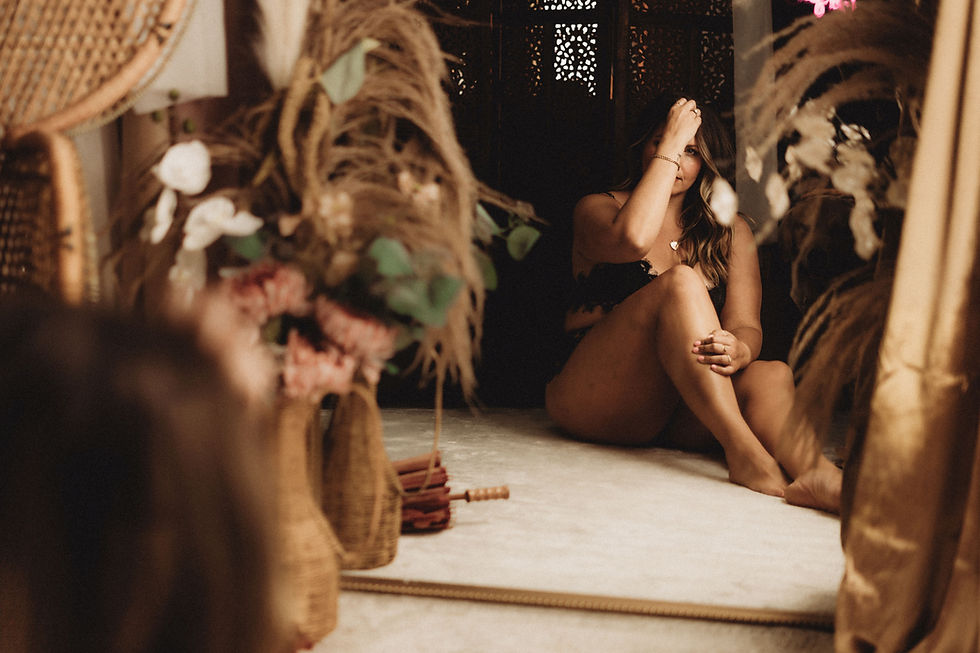 a woman overcoming insecurities during a boudoir session