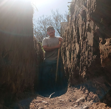 Isaac the owner of First Rate Plumbing in a trench
