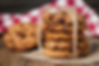 freshly baked chocolate chip cookies on rustic wooden table.jpg