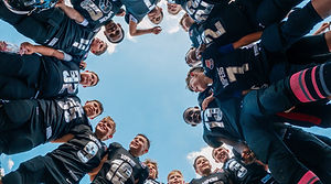 Football players huddled in a circle