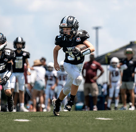 FPPW youth football player running the football