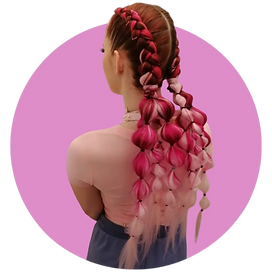 Woman with intricate pink and white festival braids, featuring bubble braid details for a bold event hairstyle.