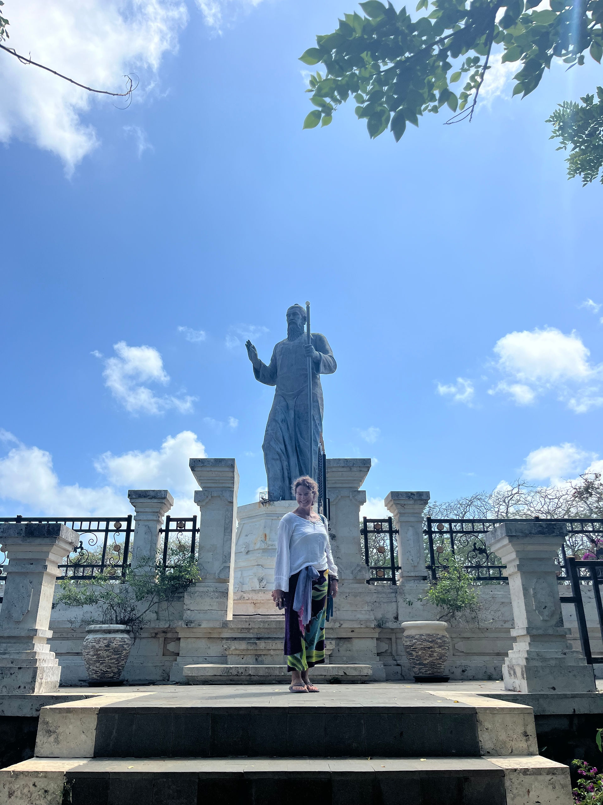 student in front of a statue in Bali