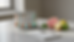 Close-up view of labeled wellness lab vials beside a notepad and fresh citrus on a counter