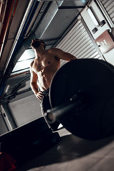 young-exhaustion-muscular-man-resting-after-heavy-cross-training-garage-gym.jpg