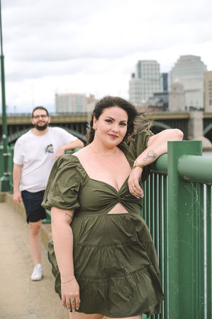 Becca and Rob on a bridge with city in background