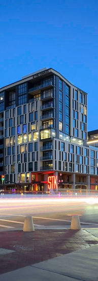 Traffic drives by the building at night