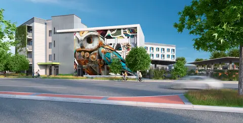 Rendering of the building. A colorful mural of an owl sits on one of the building walls 