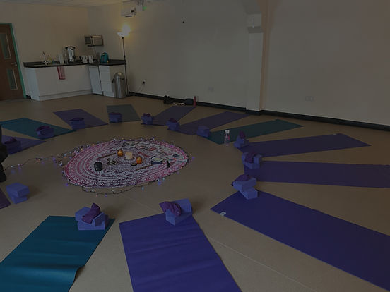 Yoga studio with mats arranged in a circular pattern for a class.