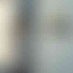 Young female swimmer smiles at her display shelf engraved “SWIM CHAMP,” holding two gold trophies and a pair of goggles.