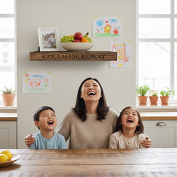 “Eat, Laugh, Repeat” oak shelf above a joyful family laughing around the dining table, surrounded by kids' drawings.
