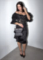 Model with the Silver Shoulder Corset Bag, a sculptural leather handbag with an hourglass silhouette and silver chain strap.