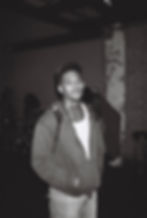 Young man in a hoodie and backward cap with neck tattoos